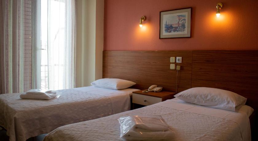 a hotel room with two beds and two lamps, Egnatia Hotel in Ioannina