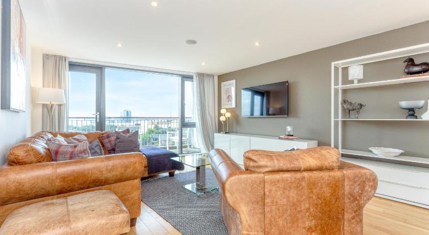 a living room filled with furniture and a large window, Executive 7 Apartments in Glasgow