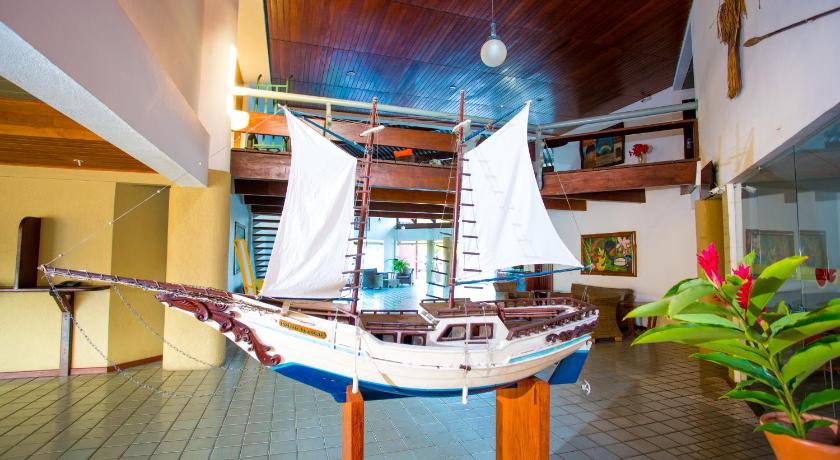 a wooden boat sitting on top of a wooden floor, Monte Pascoal Praia Hotel in Porto Seguro