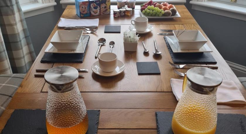 a table with a glass of orange juice on it, Borlum House B&B, Reay in Thurso