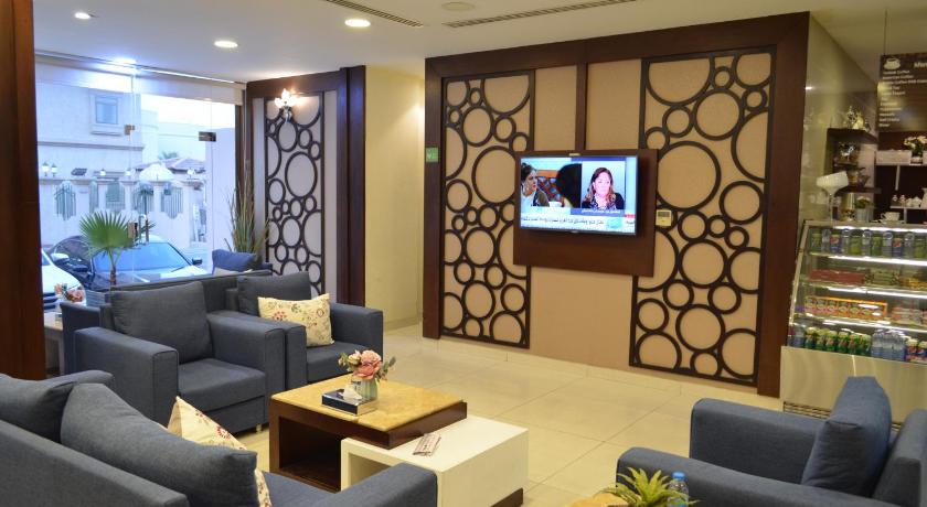 a living room filled with furniture and a tv, OYO 154 Olaya Houses in Al-Khobar