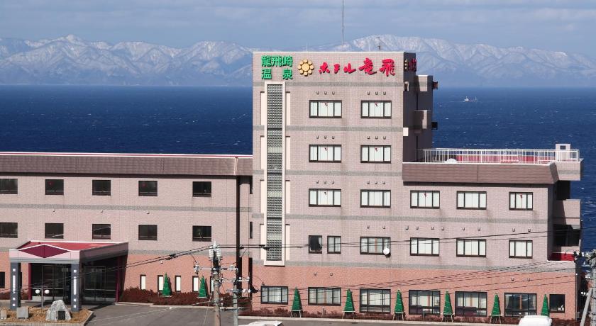 a large building with a clock on top of it, Hotel Tappi in Sotogahama