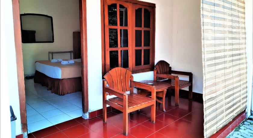 a room with a toilet and a table in it, Hotel Perdana in Klaten