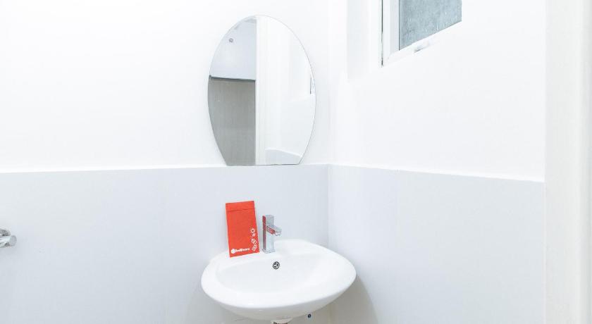 a white sink sitting under a mirror in a bathroom, RedDoorz @ Pasay Centrale Hotel in Manila