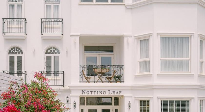 a large white building with a large window, Notting Leaf BnB in Penghu