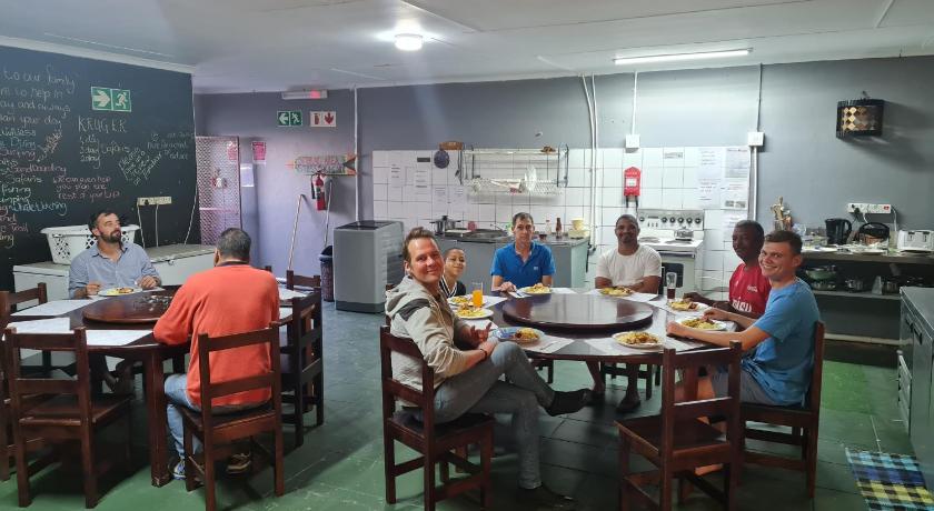 people sitting at a table in a restaurant, Mile Crunchers Backpackers & Hostelling in Mossel Bay