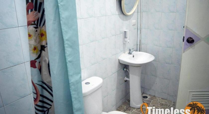 a bathroom with a toilet, sink, and shower stall, Timeless Hostel in Koh Samui