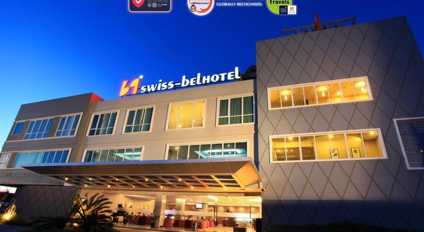 a large building with a sign on the side of it, Swiss-Belhotel Kendari in Kendari