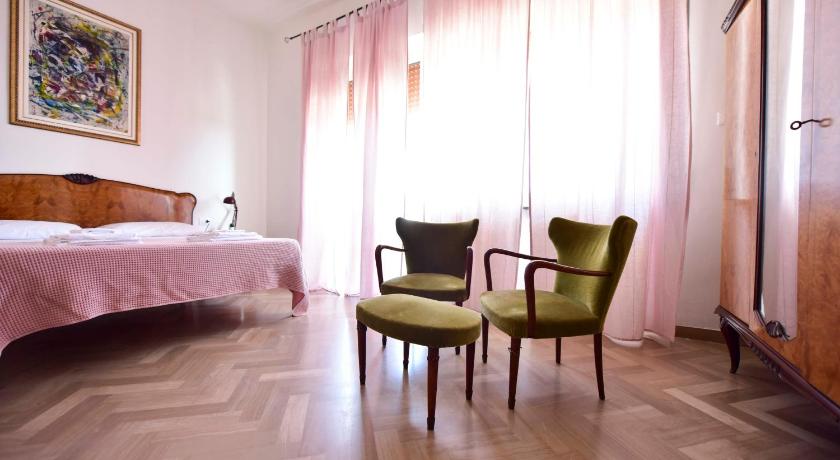 a room with a bed, chair, table and window, B&B Casa Roveri in Ortona