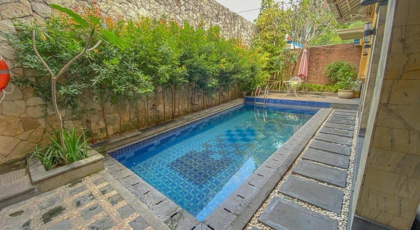 a pool of water surrounded by stone walls, Le Krasak Boutique Hotel in Yogyakarta