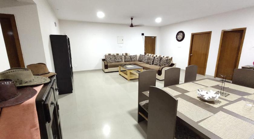a living room filled with furniture and a tv, PARADISE HOME STAY in Visakhapatnam
