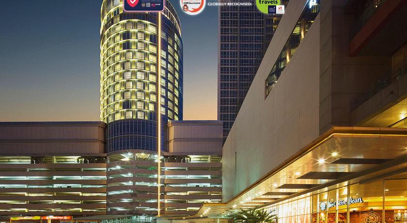 a city street filled with lots of tall buildings, Hotel Ciputra World Surabaya managed by Swiss-Belhotel International in Surabaya