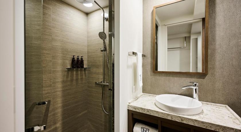 a bathroom with a sink and a mirror, The Royal Park Canvas Kyoto Nijo in Kyoto