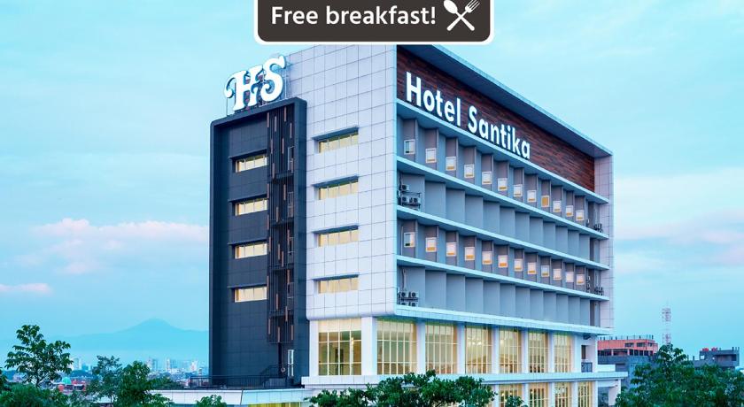 a large building with a clock on the front of it, Hotel Santika Pasir Koja Bandung in Bandung