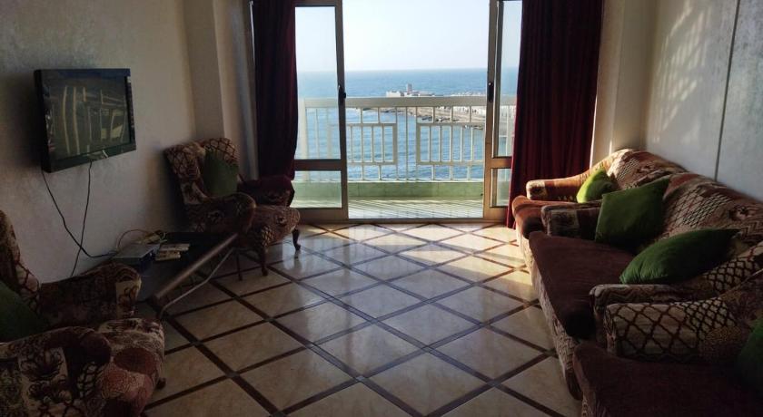 a living room filled with furniture and a dog, Gleem SeaView in Alexandria