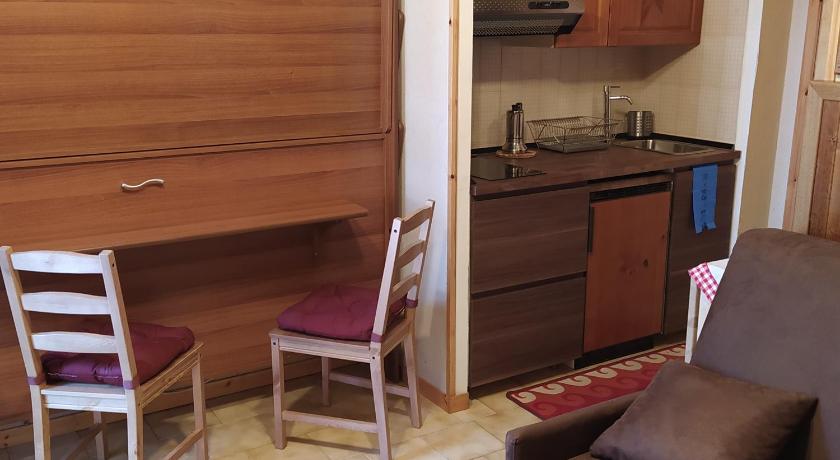 a kitchen with a wooden floor and wooden cabinets, Casa Giovy in Roccaraso