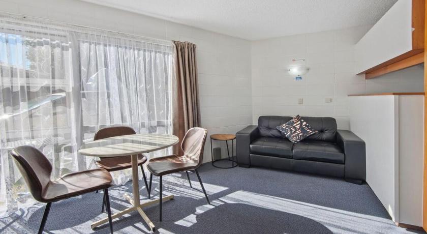 a living room filled with furniture and a window, Motel Six in Whangarei