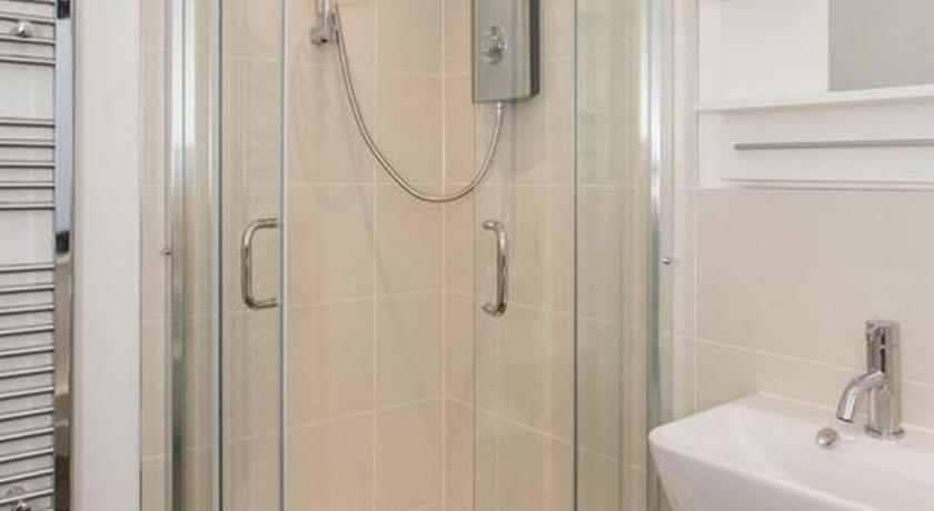 a shower stall with a glass shower door, Manor House Studios in London