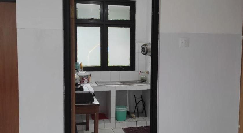 a kitchen with a sink and a door, KEY HOMESTAY in Puncak