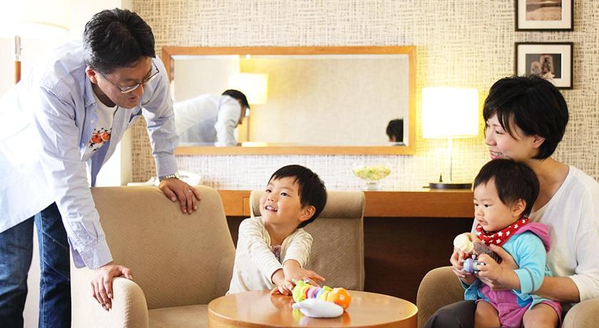 a man and a woman sitting at a table with a baby, Hotel Castle Yamagata in Yamagata