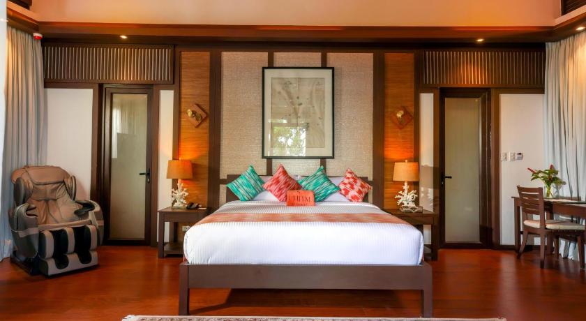 a bedroom with a large bed and a large window, Lihim Resorts in Palawan