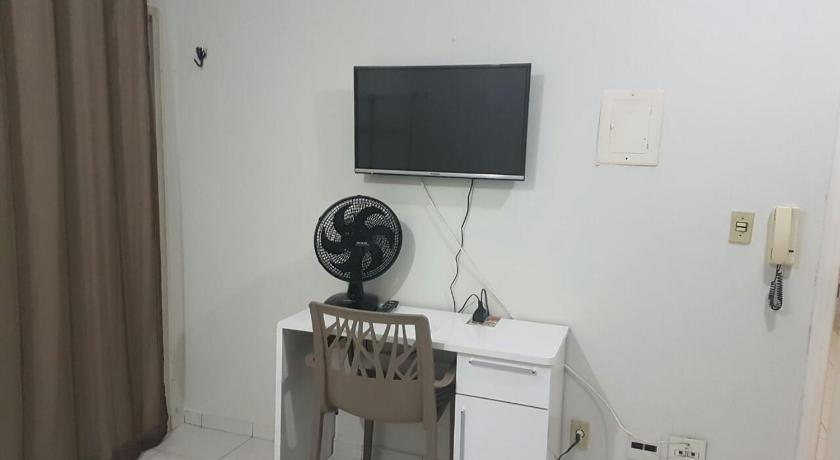 a television is on in the corner of a room, Asa Norte in Brasilia