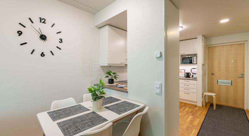a kitchen with a large clock on the wall, StarHomes Double lux 8 in Oulu