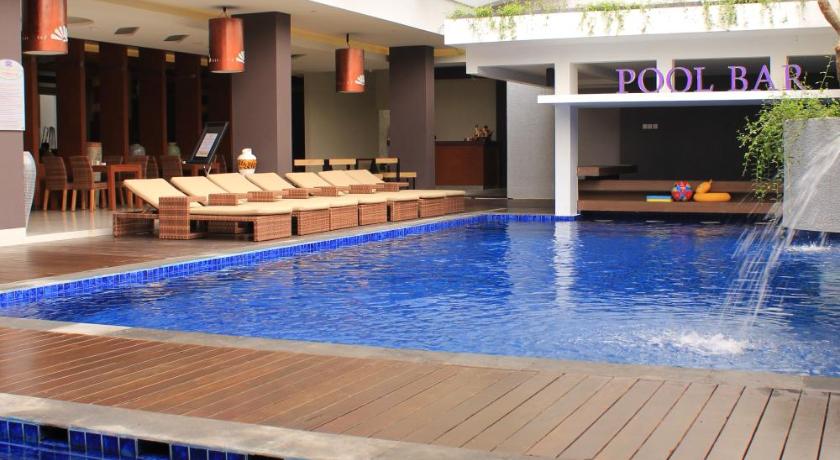 a large swimming pool in a large building, Crystal Lotus Hotel Yogyakarta in Yogyakarta