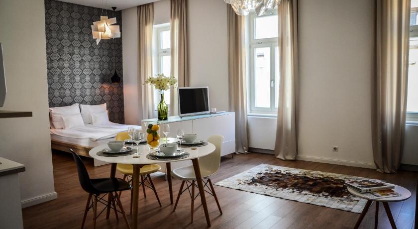 a living room filled with furniture and a tv, Baross Boutique Apartman - Urban Rooms in Gyor