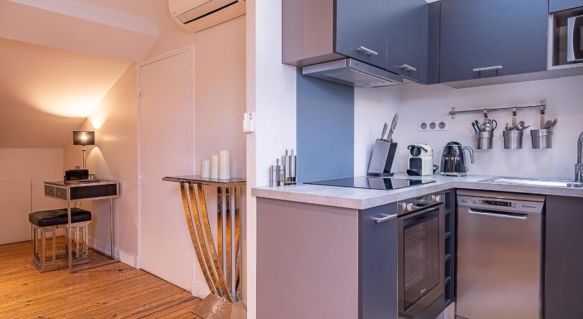 a kitchen with a stove, refrigerator, sink and dishwasher, Appartements Place Gambetta - YBH in Bordeaux