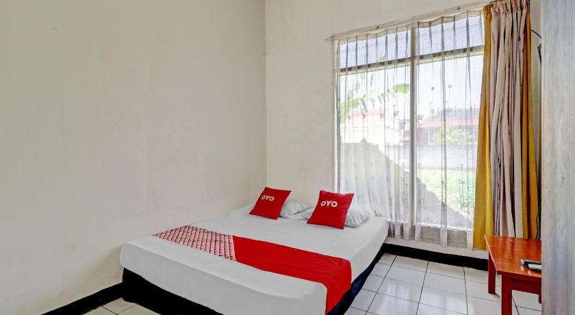 a hotel room with a large bed and a large window, OYO 90621 Pondok 23 in Bandung
