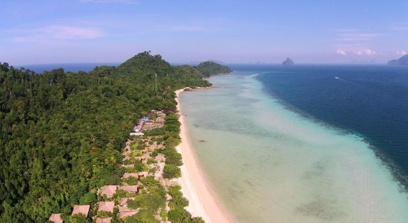a beach with a view of the ocean and mountains, The Sevenseas Resort in Trang