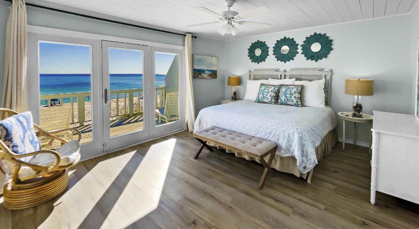 a hotel room with a bed, chair, and table, On the Beach Townhouse in Inlet Beach (FL)