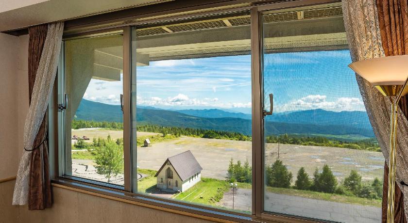 a window with a view of a lake and mountains, Palcall Tsumagoi Resort in Tsumagoi
