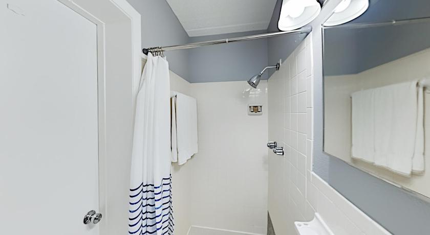 a bathroom with a toilet, sink, and shower stall, Sunset Beach Condos in Madeira Beach (FL)