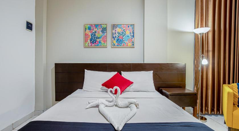 a bed that has a picture on it, Prime Cailendra Hotel RedPartner near Malioboro Yogyakarta in Yogyakarta