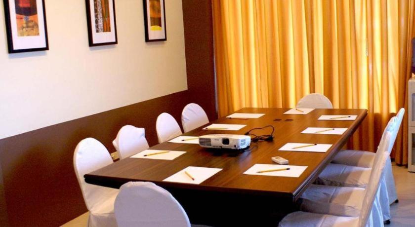 a dining room table with two chairs and a table cloth, Alpa City Suites Hotel in Cebu