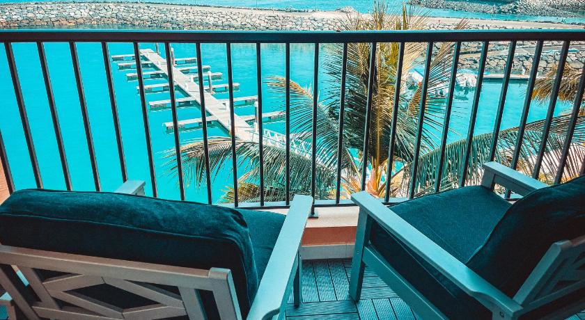 a living room with a balcony overlooking the ocean, Mina Al Fajer Apartments in Fujairah