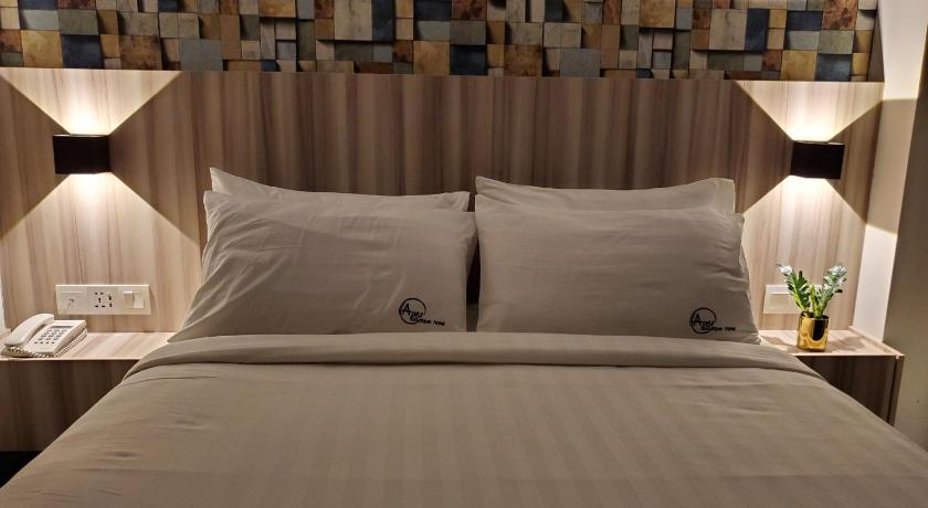 a bed with a white comforter and pillows, Apex Boutique Hotel @ Bandar Sunway in Kuala Lumpur