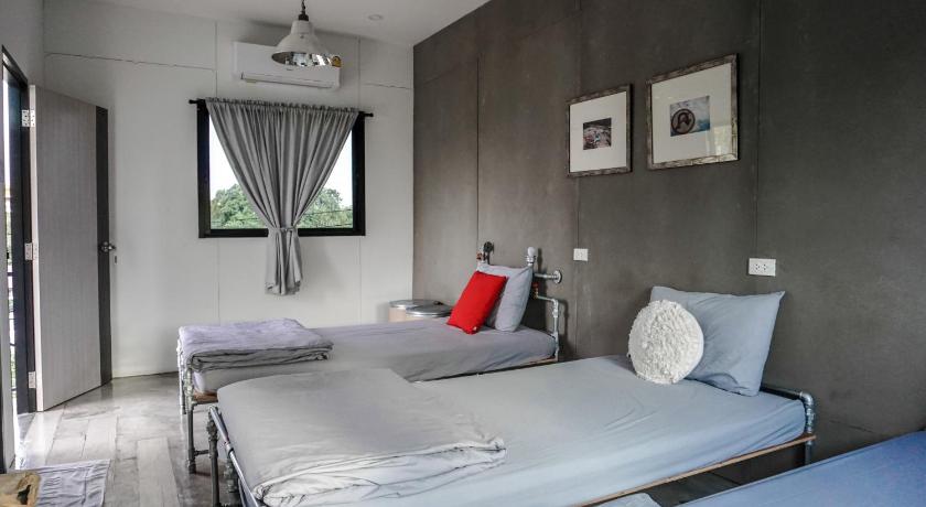 a hotel room with a bed and a desk, Patoey House in Chonburi
