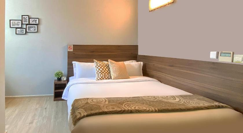 a bedroom with a bed and a lamp, ST Signature Bugis Beach, SHORT OVERNIGHT, 8 hours: 11PM-7AM (SG Clean) in Singapore