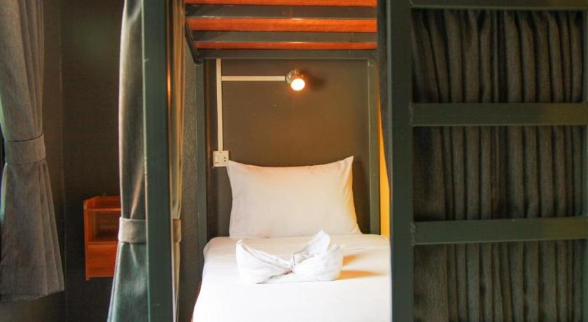 a bedroom with a bed and a canopy, Pond's Hostel in Ko Tao
