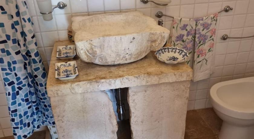 a bathroom with a sink and a toilet, Trulli del Carmine in Martina Franca