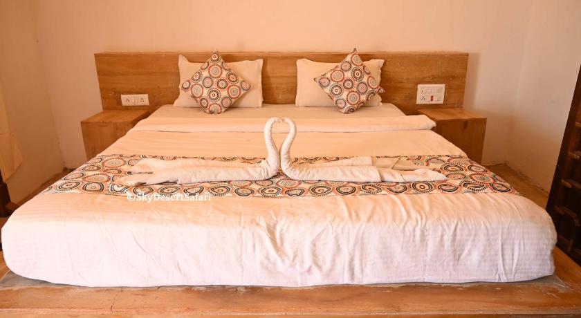 a bed that has two pillows on it, Sky Desert Safari Camp Jaisalmer in Jaisalmer