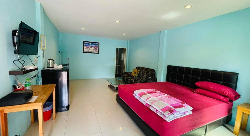 a room with a bed, a couch, and a table, Baan Sri Family in Prachinburi
