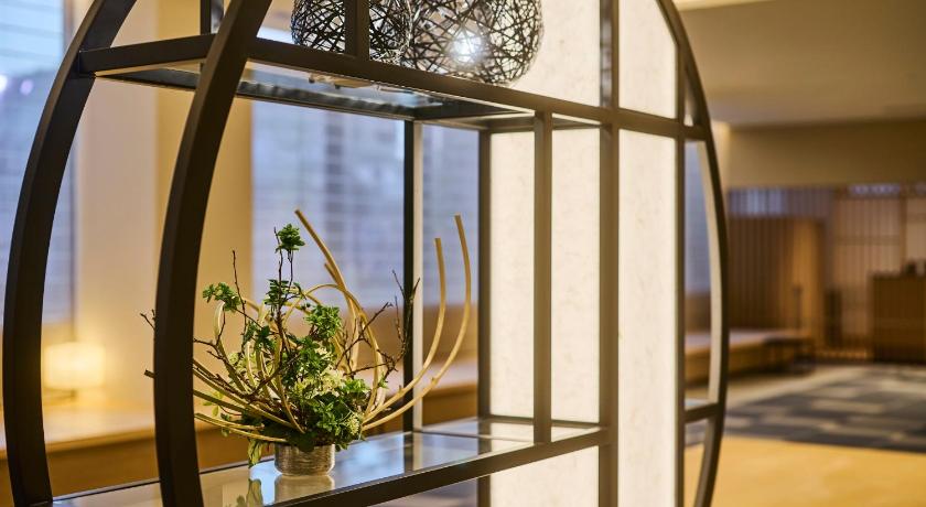 a glass vase filled with flowers on top of a table, The Royal Park Hotel Kyoto Umekoji in Kyoto