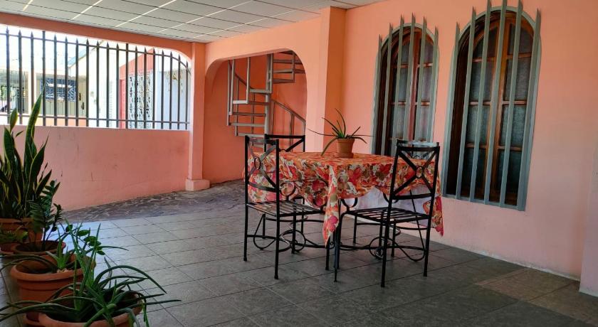 a dining room area with a table and chairs, Casa Robles - Room close to Airport #2 in Managua