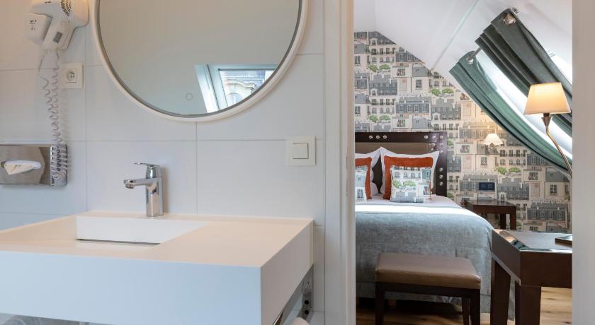 a hotel room with a bed and a mirror, Hotel Le 46 in Paris