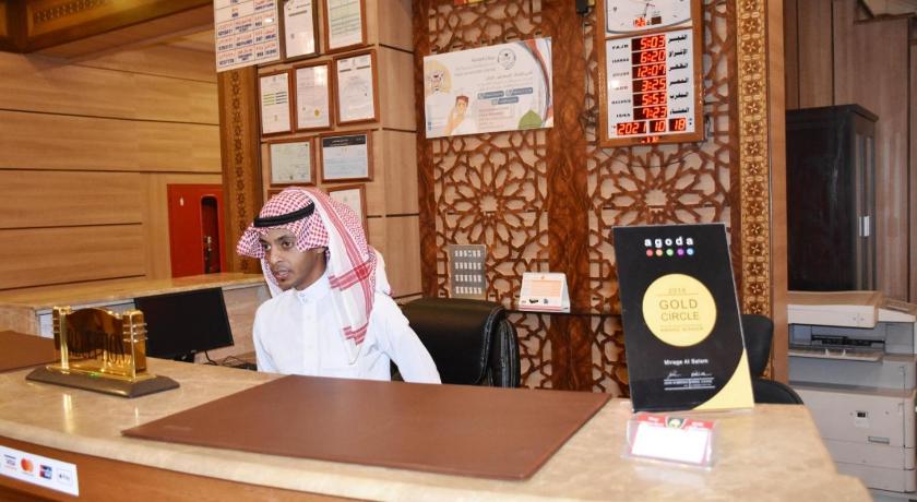 a man sitting at a desk in front of a computer, Mirage Al Salam in Medina