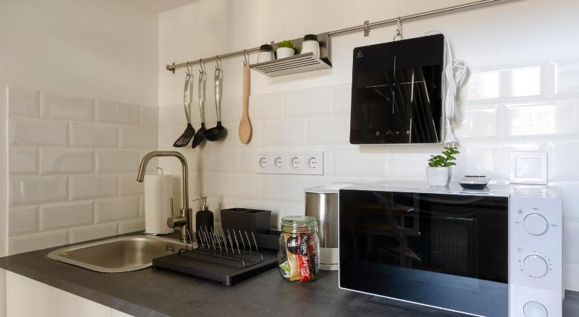 a kitchen with a stove top oven and a microwave, Bartok Suites in Budapest
